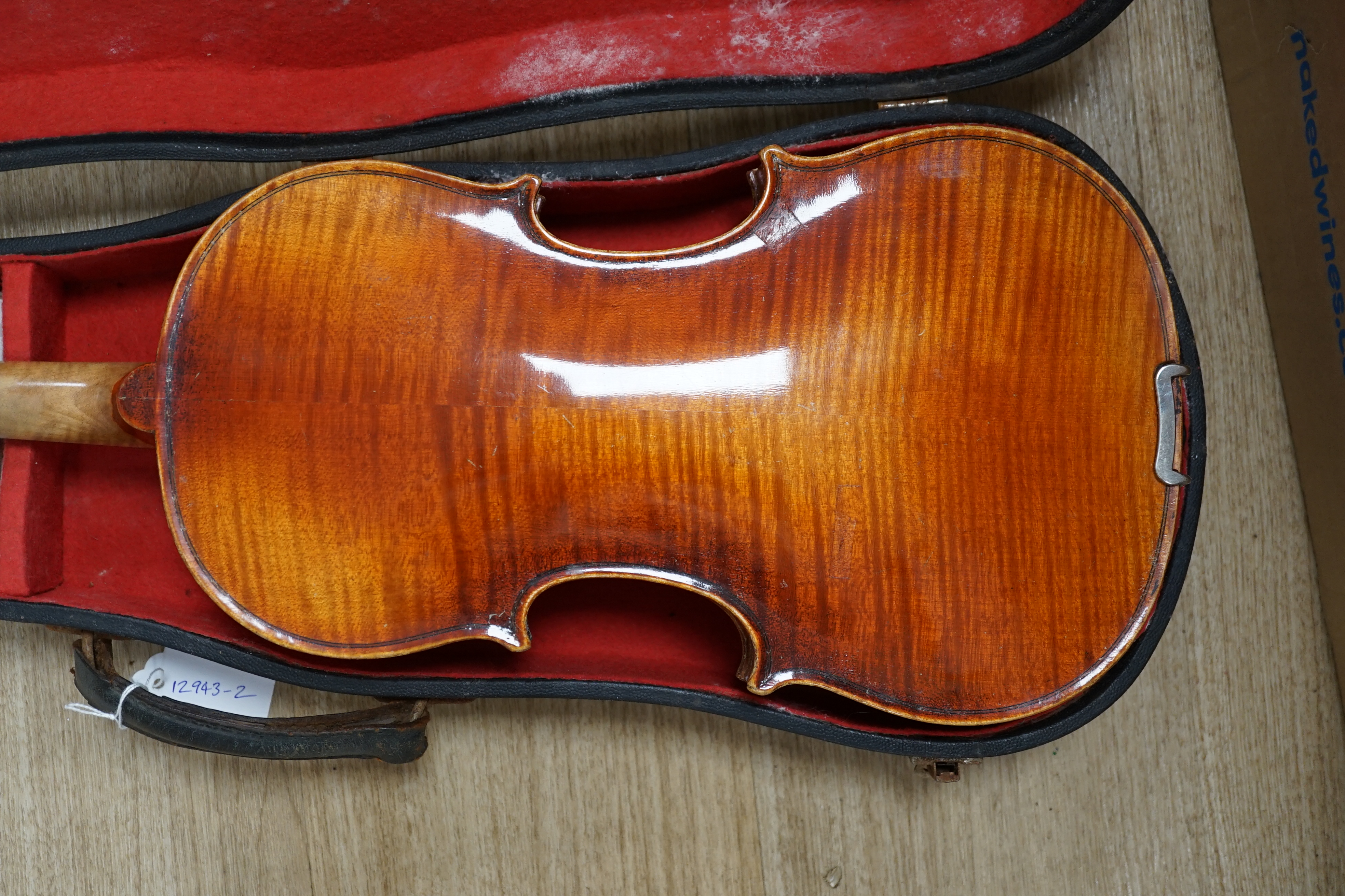 A cased Czechoslovakian student’s violin with Stradivarius label, length of body, 35.5cm, with spare strings